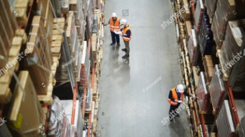 stock photo above view of warehouse workers group in aisle between rows of tall shelves full of packed boxes